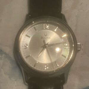 Bulova Silver Dial with Black Leather Strap. Needs battery.